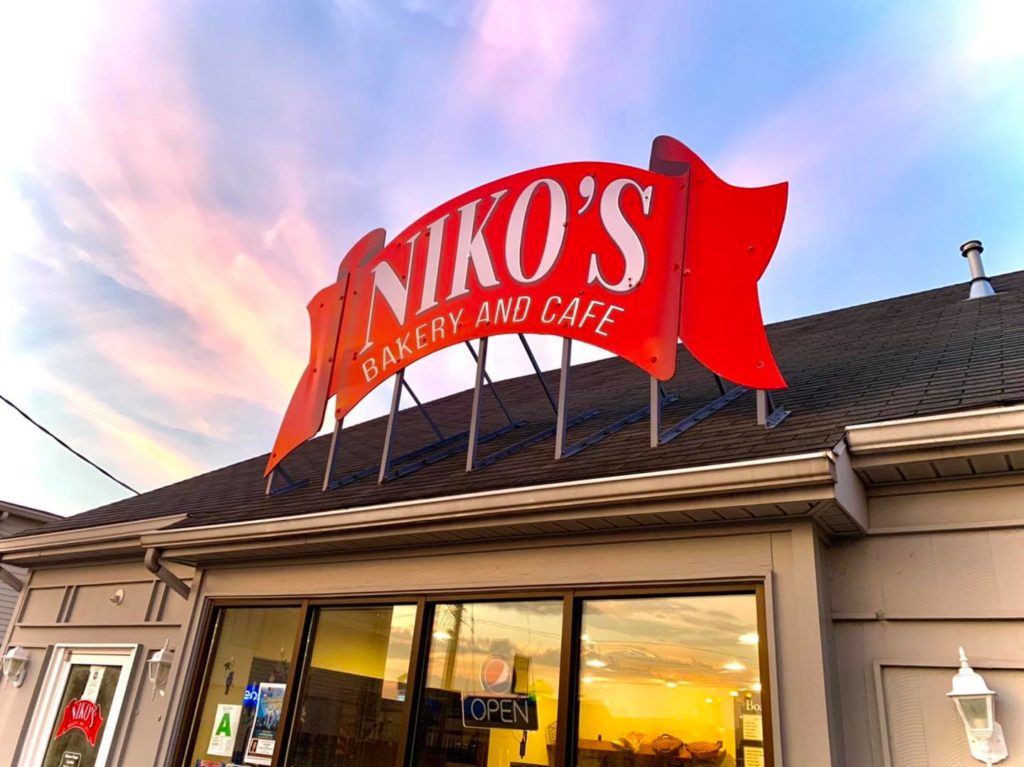 Niko's Bakery & Cafe storefront at sunset in Wesleyan Park Plaza