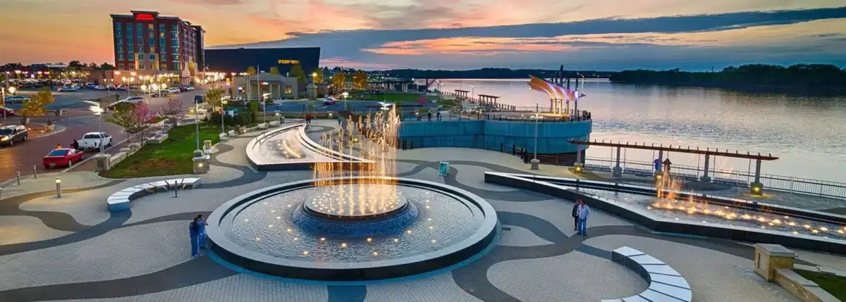 Smothers Park fountains and the Owensboro riverfront at sunset