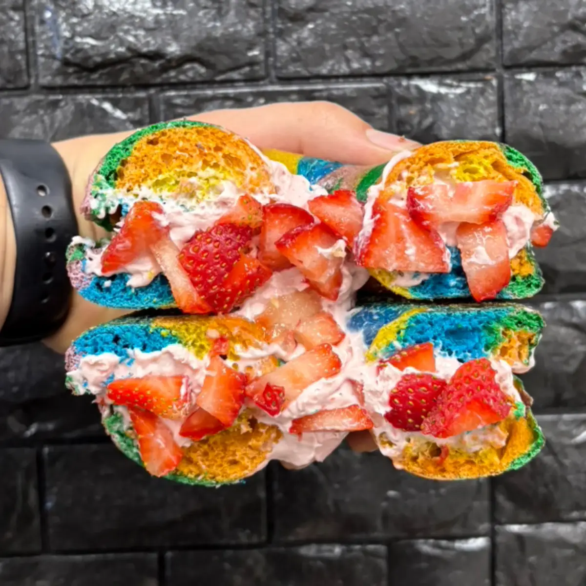 Colorful New York-style bagel with strawberry cream cheese from Libertalia Coffee and Bagels